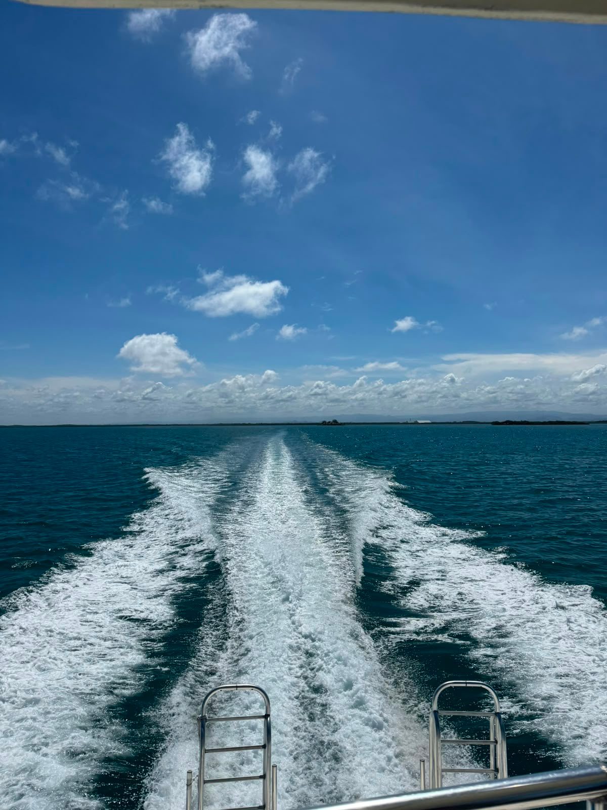 The wake behind the boat across turquoise water
