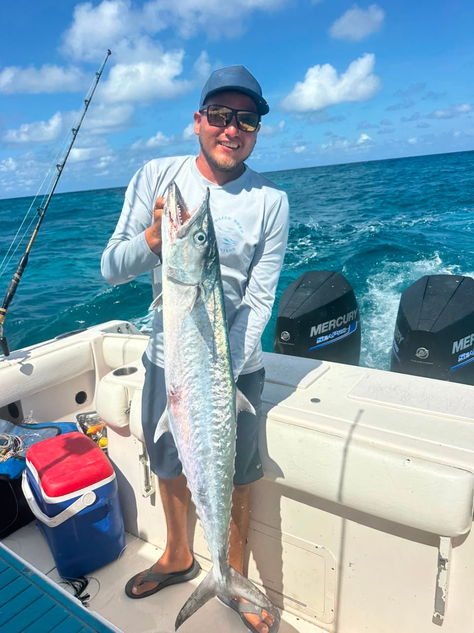Angler holding a kingfish at the stern on the run back in