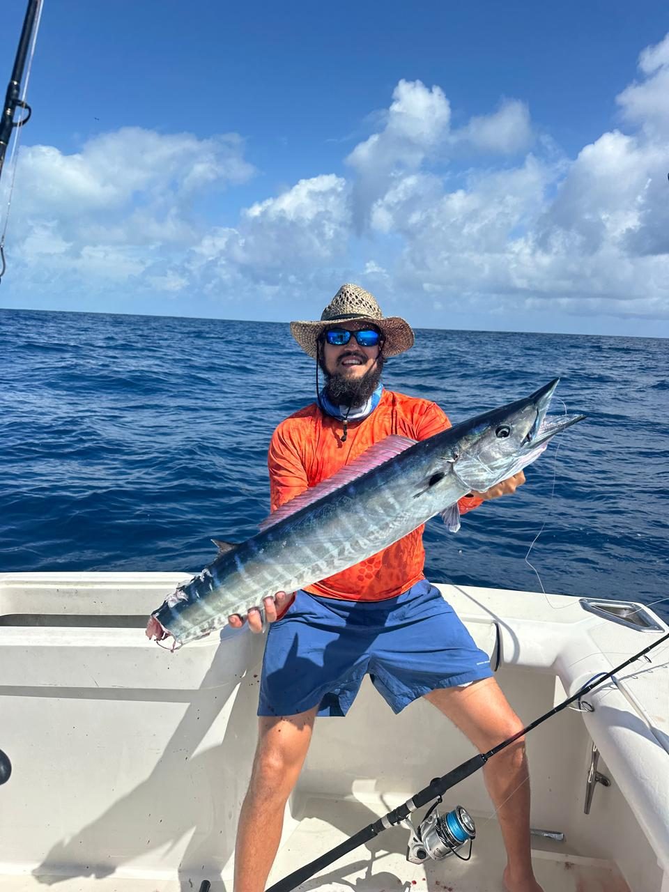 Angler holding up a big wahoo caught off Belize